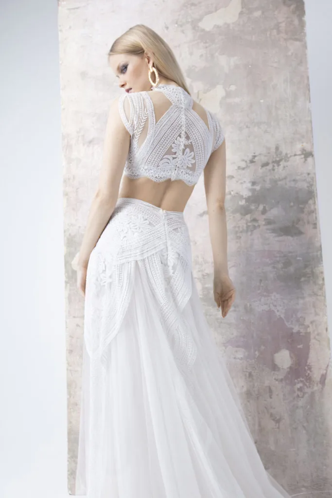 Separates wedding dress composed by a lace bodysuit with open back, a satin  crop top under it and a long satin skirt with pockets